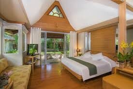 Beach Garden Bungalow bedroom with a peaked wood ceiling